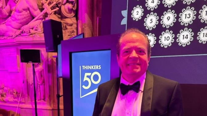 Ken Gavranovic in a tuxedo before a Thinkers50 sign at the awards gala