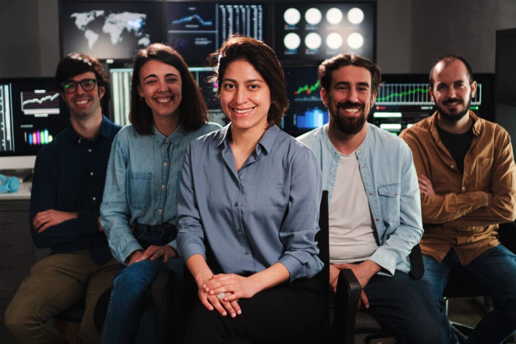 Portrait of happy high-performance teams of product and engineering employees posing for a photo at work.